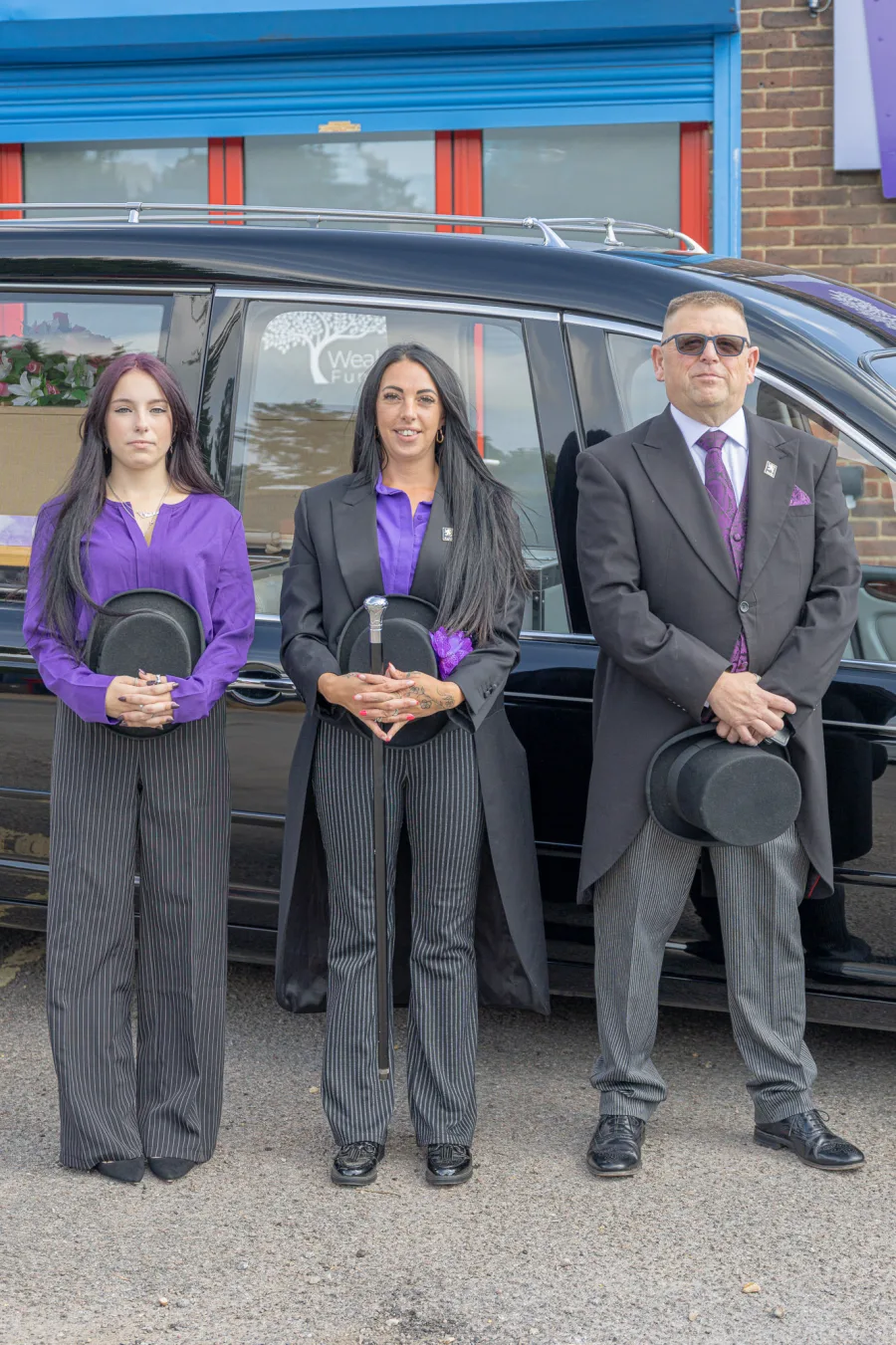 Tiah, Stacie and Andy from Wealden Funeral Services beside the hearse