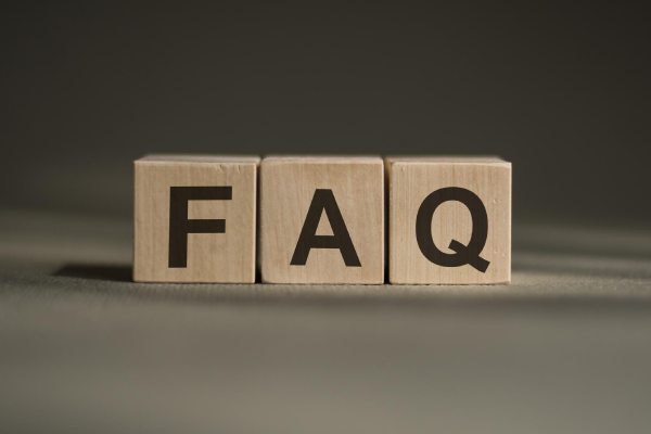 Word faq made with wood building blocks on a gray background